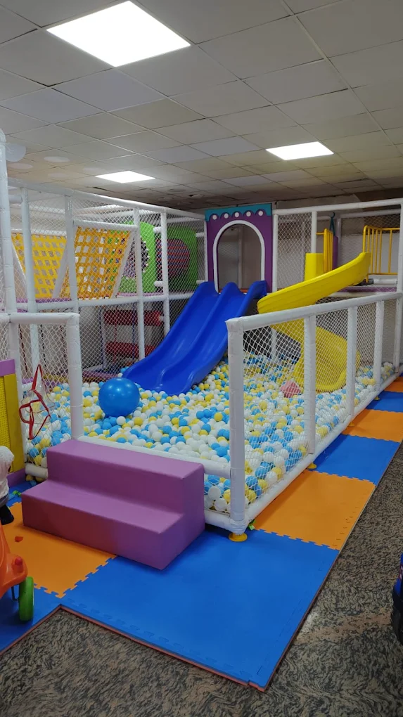 Blue and yellow slides ending in a giant ball pool